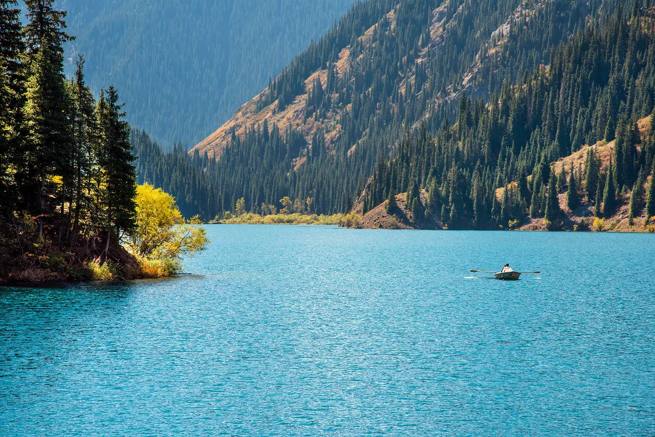 A rowing boat on the turquoise water of Kolsai Lake