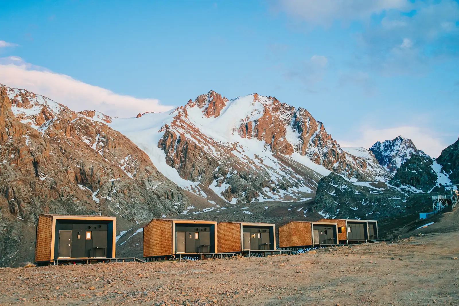 Mountain lodges under snow-covered peaks