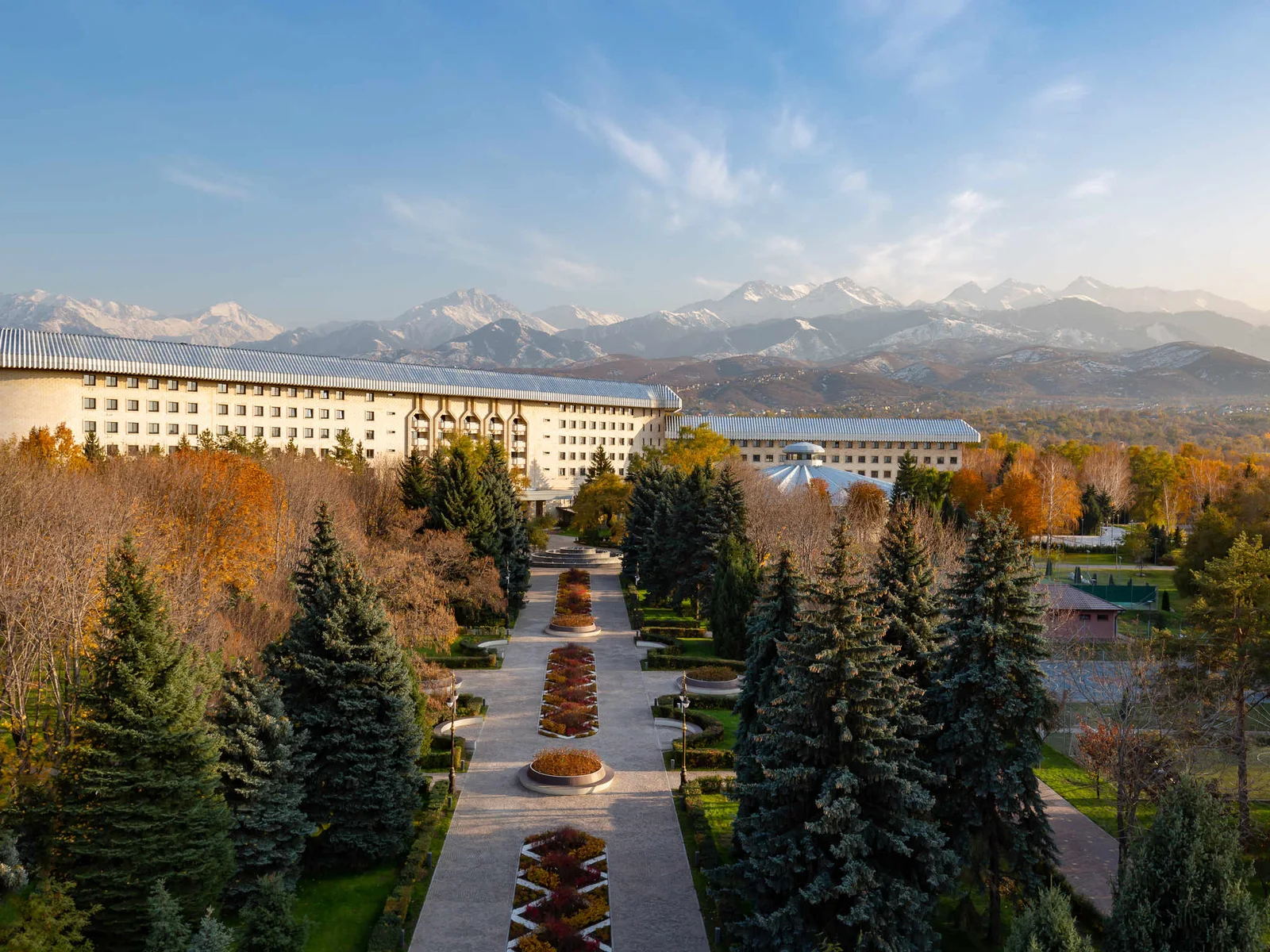 Swissôtel Wellness Resort Alatau Almaty, its park and the Trans-Ili Alatau behind it